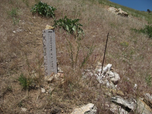 Leonard Piper's cross lies in ruins. All that remains intact is the rebar that once held the cross.