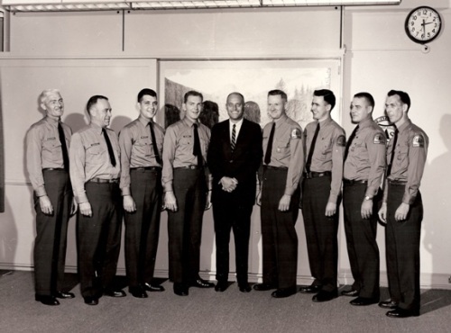 John A. Mattoon (center) with fellow employees showing off their new Forest Service shoulder emblems at the Pisgah Ranger District, Pisgah National Forest, 1963